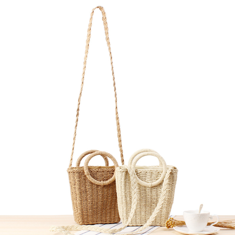 新しい清ちゃん初心者が斜め掛け両用の編みバッグを持っているinsリゾートビーチの草編みバッグ